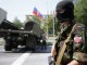 A member of a newly-formed pro-Russian armed group called the Russian Orthodox Army mans a barricade near Donetsk airport May 29, 2014.  Pro-Russian separatists shot down a Ukrainian army helicopter on Thursday, killing 14 soldiers including a general, as government forces pressed ahead with an offensive to crush rebellions in the east swiftly following the election of a new president.  REUTERS/Maxim Zmeyev (UKRAINE  - Tags: POLITICS CIVIL UNREST) - RTR3RDD8